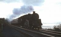 A Gourock - Glasgow Central semi-fast runs east alongside the Clyde at Langbank in August 1965. The locomotive is Polmadie Standard Class 5 4-6-0 no 73099. <br><br>[G W Robin 26/08/1965]