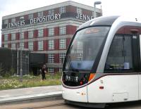 A jogger about to overtake an eastbound Edinburgh tram at Balgreen on 8 July 2014.<br><br>[John Yellowlees 08/07/2014]