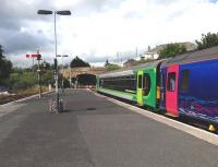 A colourful train for Newquay about to switch between main line and branch line platforms at Par station on 8 July 2014 following its arrival from Penzance.<br><br>[Bruce McCartney 08/07/2014]