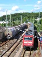 On 13th June the 16.42 Stralsund-Ostseebad Binz IC service passes a rake of aggregates wagons at Bergen auf Ruegen. Although primarily a holiday island, rail freight is still generated on Ruegen by the massive Sassnitz Mukran ferry complex where train ferries operate to Lithuania, Russia and Sweden.<br><br>[David Spaven 13/06/2014]