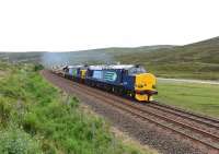 DRS liveried 37259 and 37610 <I>'T S (Ted) Cassady 14.5.61-6.4.08'</I>, growl up the gradient south of Dalnaspidal on 30 June with a train of ten autoballasters for engineering works at Achnasheen.<br><br>[John Gray 30/06/2014]