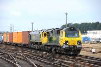 A Southampton bound container train approaching Eastleigh station on 9 July behind Freightliner 70014, with a second locomotive (66596) out of use.<br><br>[Peter Todd 09/07/2014]