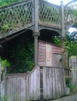 The cabin under the old footbridge at Phoenix Lane, Dunfermline, in 2014 [see image 47932] from which the level crossing gates and associated signals were operated. The external wooden telephone box is still intact and the metal plate on the cabin wall marks the position of the chimney from the stove inside. Brackets are visible in the footbridge latticework which supported the chimney extension above the bridge. [Information kindly provided by Mr Nairn, the last crossing keeper]<br><br>[Grant Robertson 05/07/2014]