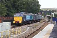 DRS 47841 is hauled east through Stalybridge on 5 July at the rear of a Liverpool to Scarborough service. The locomotive on the front end is 47853. The train was leased by TPE to supplement services during day 1 of the <I>Tour de France</I>.<br><br>[John McIntyre 05/07/2014]