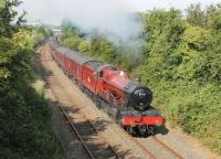 On the second of two <I>Wizards Express</I> excursions to York, 5972 <I>Olton Hall</I>, aka <I>Hogwarts Castle</I>, sets out on the Little North Western from Carnforth towards Settle. The train has just passed under the M6 motorway bridge, mid way between Carnforth and Borwick. <I>'Hang on... isn't that...'</I> [See image 47960]<br><br>[Mark Bartlett 12/07/2014]