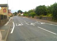 Looking north east along Stoney Lane, towards Chapelthorpe, with the full width lower section of the blue brick abutment to the former overbridge, on the Middlestown Junction to Notton Junction line (closed 1968), still in situ on the right. The bridge spanned the road just before the Bay Horse public house on the left, and acted as the boundary between Chapelthorpe village and Hall Green which is located at this side. <br><br>[David Pesterfield 11/07/2014]