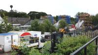 View south east across Dunblane station from the upper level of Stirling Council's Springfield Terrace car park on 8 July 2014. Work continues apace on the new <I>unified footbridge</I> which will connect the lower level of the car park to the station. The original station-only footbridge is visible centre frame. [See image 17453]<br><br>[Colin Martin 08/07/2014]