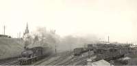 D41 4-4-0 no 62229 leaves a smokescreen over a busy Fraserburgh goods yard on 15 July 1950 as it gets underway with the mid-day train for Aberdeen.<br><br>[G H Robin collection by courtesy of the Mitchell Library, Glasgow 15/07/1950]