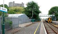 Harlech Castle looks down on the 12.26 to Birmingham International preparing to depart on 9th July 2014. <br><br>[Colin McDonald 09/07/2014]