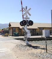 Railroad Crossing at Tehachapi Depot, California on the Union Pacific line connecting Bakersfield and Mojave in April 2014. The station closed in the 1960s. The depot building (rebuilt) beyond the crossing houses an excellent railway museum.<br><br>[Brian Taylor 15/04/2014]
