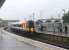 Passengers waiting in very heavy rain at Poole on 23rd May 2014 were glad of the large platform shelters. SWT 444037 pulls in on a stopping service for Waterloo ex-Weymouth. The arched roof sections of the modern station building can be seen to the right of the train.<br><br>[Mark Bartlett 23/05/2014]