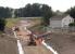 The Borders Railway route through Shawfair, looking north towards Newcraighall on 27 June 2014. Construction work on the platforms and footbridge of Shawfair station is well underway, with the new flyover crossing the formation visible just beyond [see image 47782].<br><br>[John Furnevel 27/06/2014]