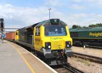 Freightliner 70018 runs through Eastleigh on 9 July 2014 with a freight heading for Southampton container port.<br><br>[Peter Todd 09/07/2014]