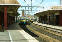 Platform scene at Deansgate station on 5 July 2014. ATW 175008 is heading west non-stop with a service for North Wales via Warrington and Chester, while a TPE service to Manchester Airport is about to pass through  eastbound.<br><br>[John McIntyre 05/07/2014]