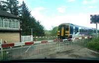 Waiting patiently at Low House level crossing  on the Settle - Carlisle line just north of Armathwaite on 12 May 2014 as the 12.49 Leeds - Carlisle service, formed by 158872, passes northbound.<br><br>[Brian Smith 12/05/2014]