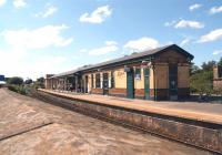 The island platform and station building at Ashton-Under-Lyne, photographed on 5 July 2014 looking west over the wall from the car park.<br><br>[John McIntyre 05/07/2014]