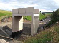 Probably the most short-sighted piece of infrastructure on the entire Borders Railway - Overbridge 41 at Cowbraehill between Tynehead and Falahill, looking south on 15th July. Under Transport Scotland's original specification this section of the route would have been double track. Following the cutback from 16 miles to just 9 miles of double track on the railway, this will now be single - and, in the absence of 'passive provision', any future attempt to double here will require complete demolition of the bridge (carrying a farm access road).<br><br>[David Spaven 15/07/2014]