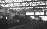 One of the 10 BR Class 9F 2-10-0s built with Franco-Crosti boilers, prior to later conversion to the standard arrangement. 92021 is passing through Carlisle station with a southbound ballast train on 22 August 1965. <br><br>[K A Gray /08/1965]