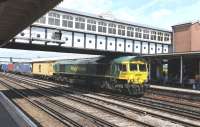 Freightliner 66591 pulls up in Eastleigh station for a crew change on 9 July 2014 with yet another train bound for Southampton container port.<br><br>[Peter Todd 09/07/2014]