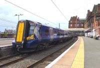 The stock for the 11.36 all-stations to Glasgow stands in platform 2 at Ayr station on 18 July (journey time 60 minutes). Platform 1 will shortly be occupied by the 10.30 from Glasgow which will return as the 11.23 fast service (journey time 49 minutes).<br><br>[Colin Miller 18/07/2014]