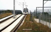 A grey morning in Edinburgh on 19 July sees a westbound tram approaching Balgreen from Murrayfield coming off the bridge over Balgreen Road - a bridge with a higher clearance than the E&G rail bridge alongside.<br><br>[John Furnevel 19/07/2014]