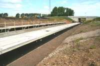 The under construction platforms at Shawfair on 20 July 2014, looking north towards Newcraighall, with the new flyover running in from Millerhill Road crossing the formation.<br><br>[John Furnevel 20/07/2014]