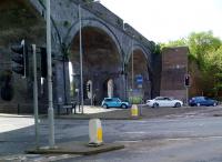 The twin track standard gauge Hughenden viaduct strides confidently over a complex traffic island in High Wycombe. The puzzle is, why does the retaining wall for the former single track broad gauge viaduct alongside look so recent? The answer is that it was built at the same time as the traffic system - about 30 years ago. This modernization swept away a number of railway arch business premises; and also, according to a lifelong resident, a rather dodgy pub.<br><br>[Ken Strachan 26/04/2014]