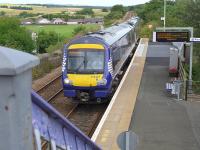 View north east over Cardenden on 21 July 2014 as 170427 arrives with a Fife Inner Circle service to Edinburgh.<br><br>[Bill Roberton 21/07/2014]