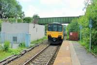 A lengthy campaign to redouble the Blackburn-Bolton line was partly successful with the opening of a two mile long dynamic loop at Darwen in 2015. However, reinstating a second track at Entwistle would have required major work. A 153/150 combination leaves the rural request stop heading for Bolton and Manchester past the relay room that was built on the old goods lines. The surviving platform was once part of an island but the other road has been filled in and an exit ramp created in place of the old footbridge. <br><br>[Mark Bartlett 20/06/2014]