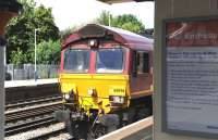 66046 at the platform at Eastleigh on 9 July with a Southampton bound freight. Note the Network Rail / South West Trains poster welcoming rail enthusiasts to this busy station, complete with normal guidelines.<br><br>[Peter Todd 09/07/2014]