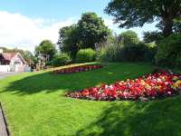 The beautifully-kept gardens on the road approach to West Kilbride station in July 2014.<br><br>[Colin Miller 22/07/2014]