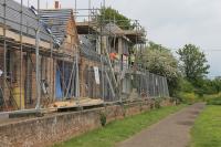 Over sixty years after closure the old station at Yarmouth on the Isle of Wight is undergoing a full restoration. The work includes creating a replica signal box (actually a tall bird hide), as seen here in this view towards Newport in May 2014. The trackbed is now a foot/cycle path. <br><br>[Mark Bartlett 20/05/2014]