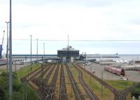 One of the electrified standard-gauge accesses to the Sassnitz Mukran ferry complex on Ruegen, seen on 19th June. The rail passenger service on this short spur from Borchtitz on the Lietzow-Sassnitz electric branch line was withdrawn some years ago, but a rake of four DB Regio coaches sits stranded to the right.<br><br>[David Spaven 19/06/2014]