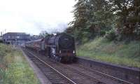 Britannia Pacific 70038 <I>Robin Hood</I> takes a Carlisle train through the deserted and overgrown platforms of Strathbungo station on 31 July 1964, just over two years after closure.<br><br>[John Robin 31/07/1964]