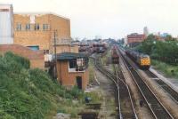 An unidentified Railfreight class 37 hauls coal up the valley (on Welsh railways, this made it an up train) past the soon-to-be-closed Cathays wagon works in 1988. The signal box seems to have succumbed already.<br><br>[Ken Strachan //1988]