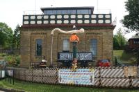 The impressive conversion of Settle water tower to domestic accommodation, complete with restored 5 plank wagon and water crane. Photographed on 26 July 2014, almost midway through the 2 month long Settle Flowerpot Festival. <br><br>[John McIntyre 26/07/2014]