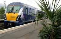 Platform scene at Carntyne on 27 July as 334010 arrives with more swimming fans heading for the Commonwealth Games events taking place at the nearby Tollcross International Swimming Centre.<br><br>[Colin McDonald 27/07/2014]