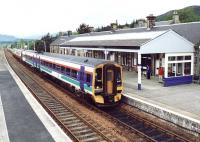 A Glasgow Queen Street - Inverness service arrives at Kingussie in September 2004. The 4-car train comprises a ScotRail liveried 158 leading an SPT liveried 156. <br><br>[John Furnevel 12/09/2004]