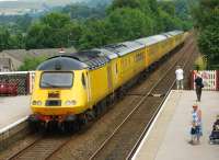 One of Network Rail's test trains heads north through Settle station on 26 July 2014 on a Derby RTC to Heaton move.<br><br>[John McIntyre 26/07/2014]
