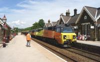 Colas locos on the 6V38 Carlisle to Chirk loaded log train on 26 July 2014 passing Settle, with 70802 doing the work and 56105 along for the ride. The Class 56 took over at Warrington when the Class 70 came off the train as it is believed that they haven't yet been cleared for the route to Chirk.<br><br>[John McIntyre 26/07/2014]