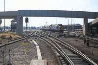 Now named Harwich International, this is the view from the west end of Harwich Parkeston Quay station on Sunday 15th August 1976. Parkeston West box (closed 1985) is in sight, as are the extensive sidings, with a Class 37/37/31 combination shunting at the yard throat. The bridge carried car traffic to and from the ferry.<br><br>[Mark Dufton 15/08/1976]