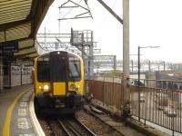 What at first glance might appear to be a super-length Commonwealth Games Special is in fact EMU 350402 entering through platform 15 at Manchester Piccadilly, with the 0900 Manchester Airport - Glasgow Central TransPennine Express service via Wigan, as a Virgin Pendolino runs across behind it into a Piccadilly stop end platform on arrival a few minutes late with the 06.55 ex Euston service.<br><br>[David Pesterfield 29/07/2014]