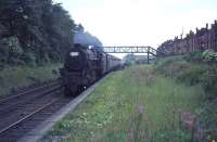 Black 5 no 44679 brings a Birmingham New Street - Glasgow Central train through the closed Strathbungo station in July 1964, having just passed below the footbridge linking Darnley Road (right) with Moray Place. The train has just over a mile to run to reach its destination.<br><br>[John Robin 31/07/1964]