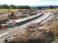 Progress at Shawfair on Sunday 3 August 2014. View is south towards Sheriffhall. The road entrance and station car park are off to the left. Newton village stands in the right background.<br><br>[John Furnevel 03/08/2014]