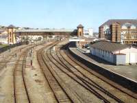 View west over Holyhead station from London Road overbridge on 23 July, showing the rarely used stabling sidings and platform 1, used mainly by Virgin Voyager services from Euston. Three of the Voyagers that stable at Holyhead, plus some Arriva DMUs, use the washing plant, located beyond the footbridge, during overnight servicing. Arriva WAG service stock and class 67 loco are stabled in the sidings over each weekend. The disused building centre right is the former Arriva crew facility and signing on point, now superceded by a new joint crew and customer service facility on platform 2.<br><br>[David Pesterfield 23/07/2014]