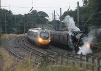 Dusk at Oubeck and, only two miles from its Lancaster destination, 8F 48151 and the returning <I>Fellsman</I> has been <I>looped</I>. This northbound Pendolino was one of four trains that overtook the steam hauled special before it got underway again.<br><br>[Mark Bartlett 06/08/2014]