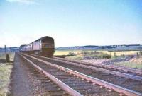 Looking north west along the WCML towards Carstairs on 10 July 1965, with the remains of Pettinain signal box visible on the up side of the line. Approaching is D1845 at the head of a Motorail service, possibly the afternoon Stirling - Newton-le-Willows. [Ref query 9874]<br><br>[John Robin 17/07/1965]