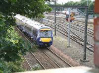 The 11.47 Newcraighall - Glenrothes with Thornton runs past the west end of Craigentinny depot on 5 August less than 2 miles from its next stop at Waverley. The yard shunter in the background is WABTEC 08472. <br><br>[John Furnevel 05/08/2014]