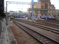 View over the west end of Leeds on 29 July sees 158s standing at bay platforms 10, 13 & 17, with a further member of the class running into through platform 8 on the left. Odd man out is the 142 Pacer at Platform 17.<br><br>[David Pesterfield 29/07/2014]