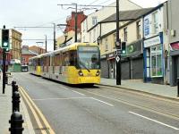 A brace of trams, led by 3061, roll down the new street running section in Rochdale towards the terminus. The sole purpose of the traffic lights appears to be to stop road vehicles while Manchester bound trams come off the short single line section and cross over to the other side of the road. <br><br>[Mark Bartlett 07/08/2014]